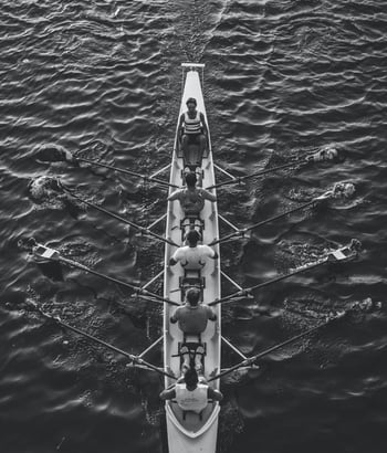 A team rowing a boat in a coordinated effort