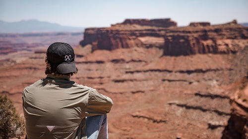 A Ninety team member gazes out over a beautiful desert vista