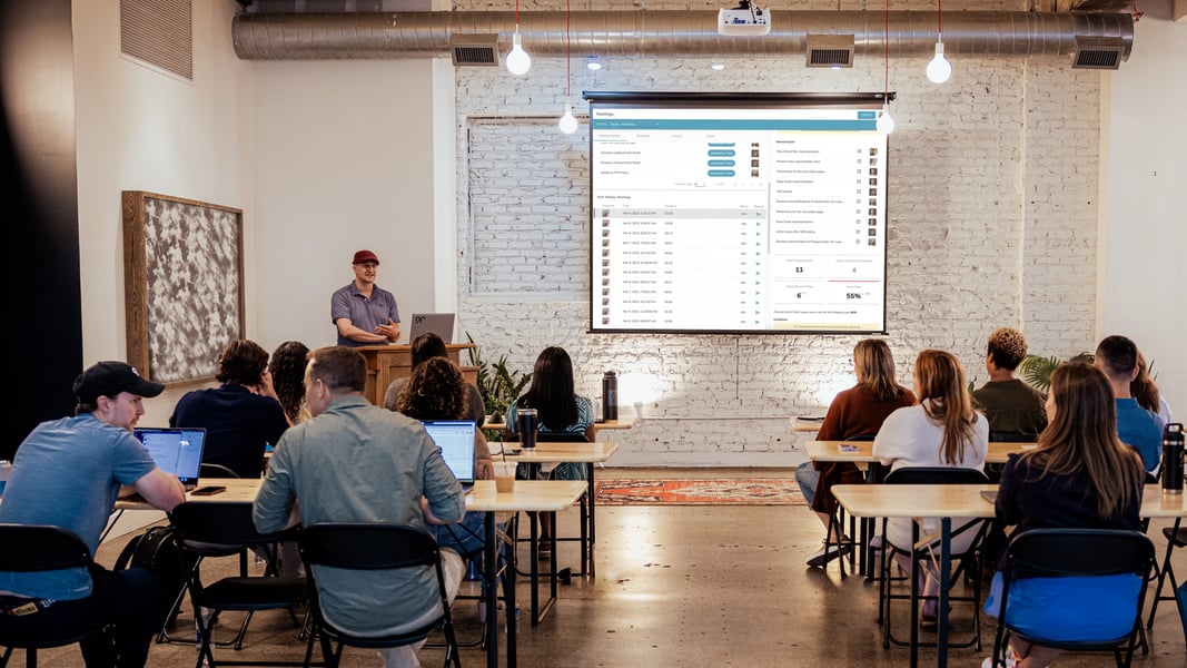 A Ninety team member leads a quarterly meeting. A Ninety team member leads a quarterly meeting.