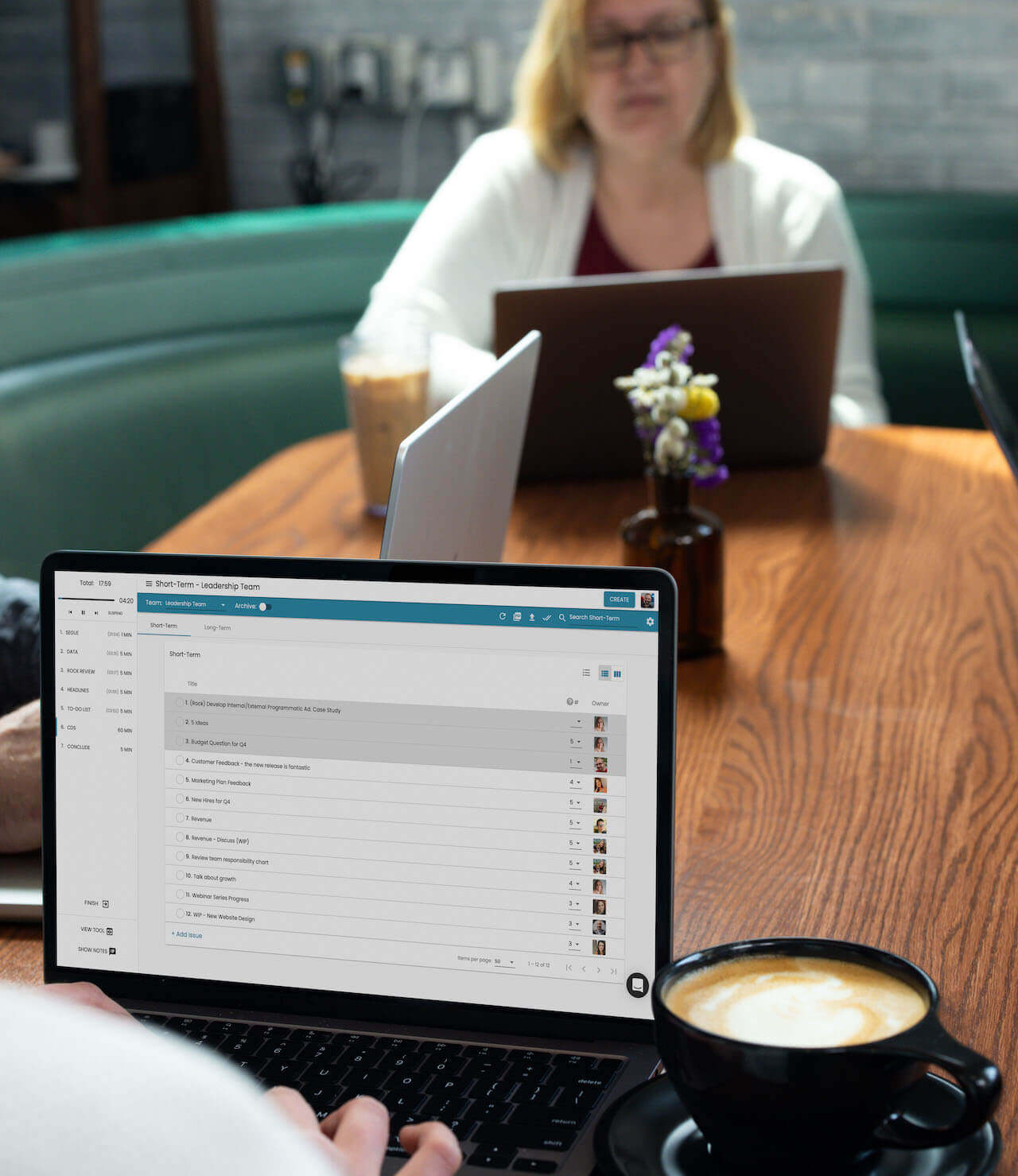 Two people working in a cafe using the Ninety app.