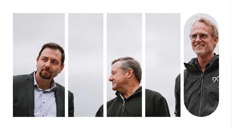 Three members of a senior leadership team standing outside, posing for a picture.