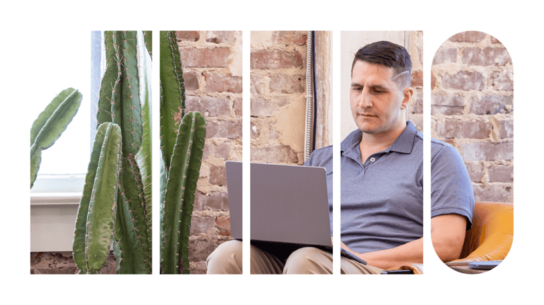An employee seated on a chair using his laptop.