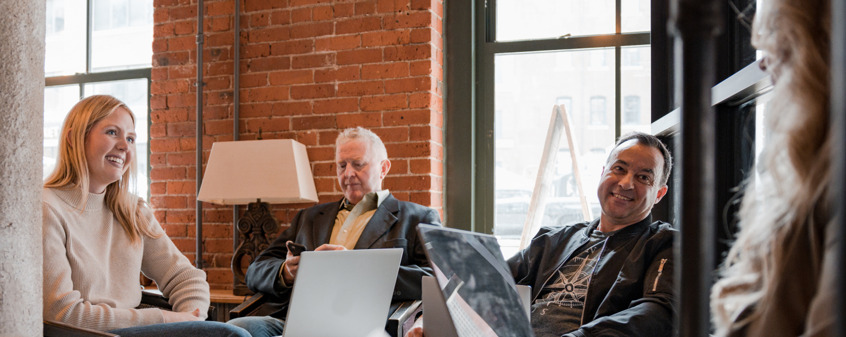 Four people working together on laptops