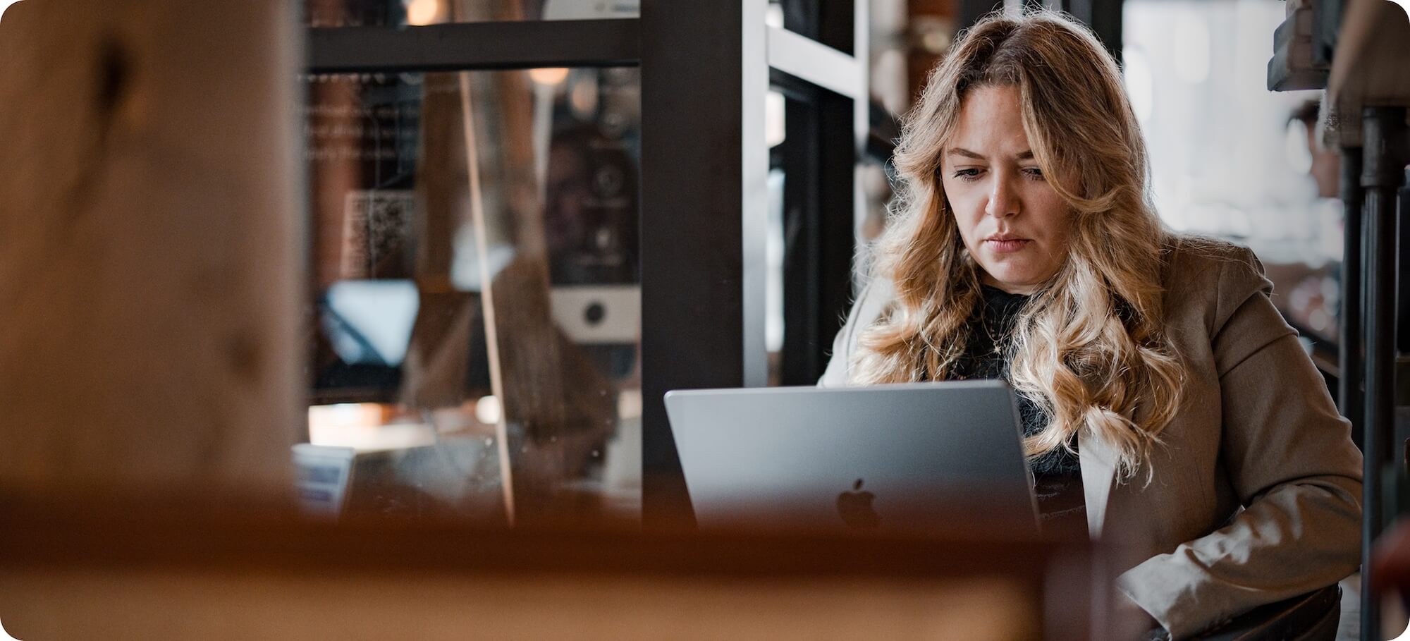 A woman at a desk working on her laptpo