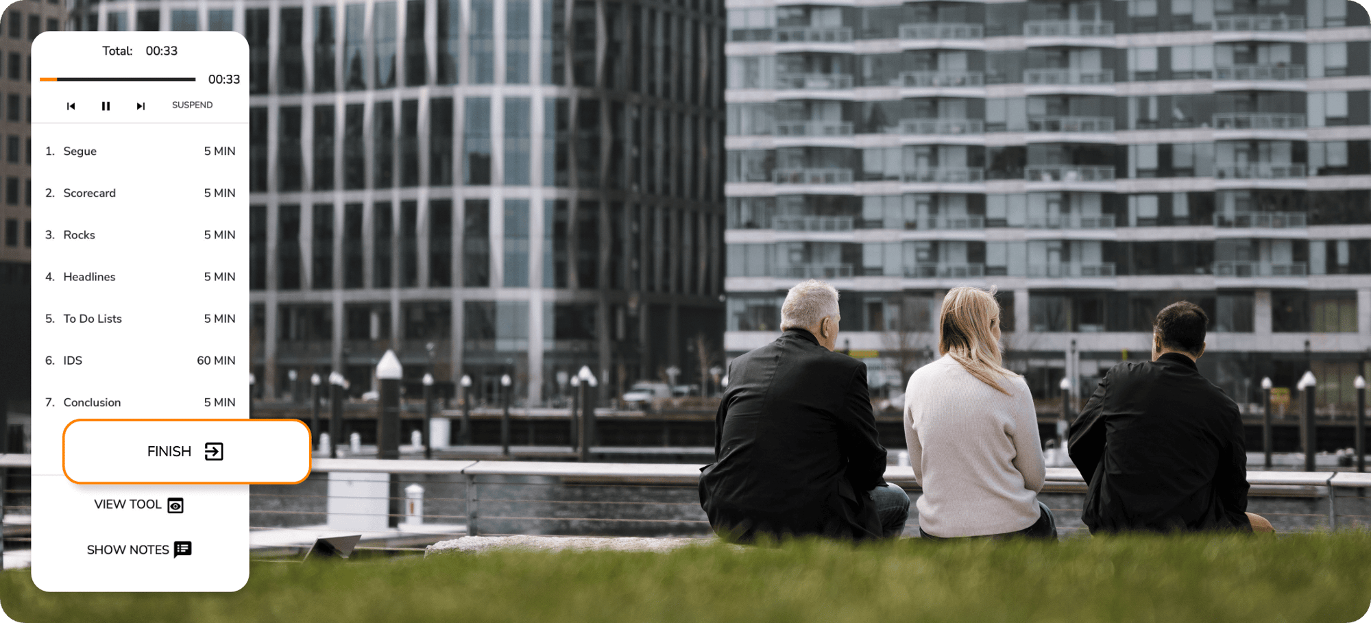 Employees sitting outside their office building. Superimposed is the meetings tool featuring the Finish button.