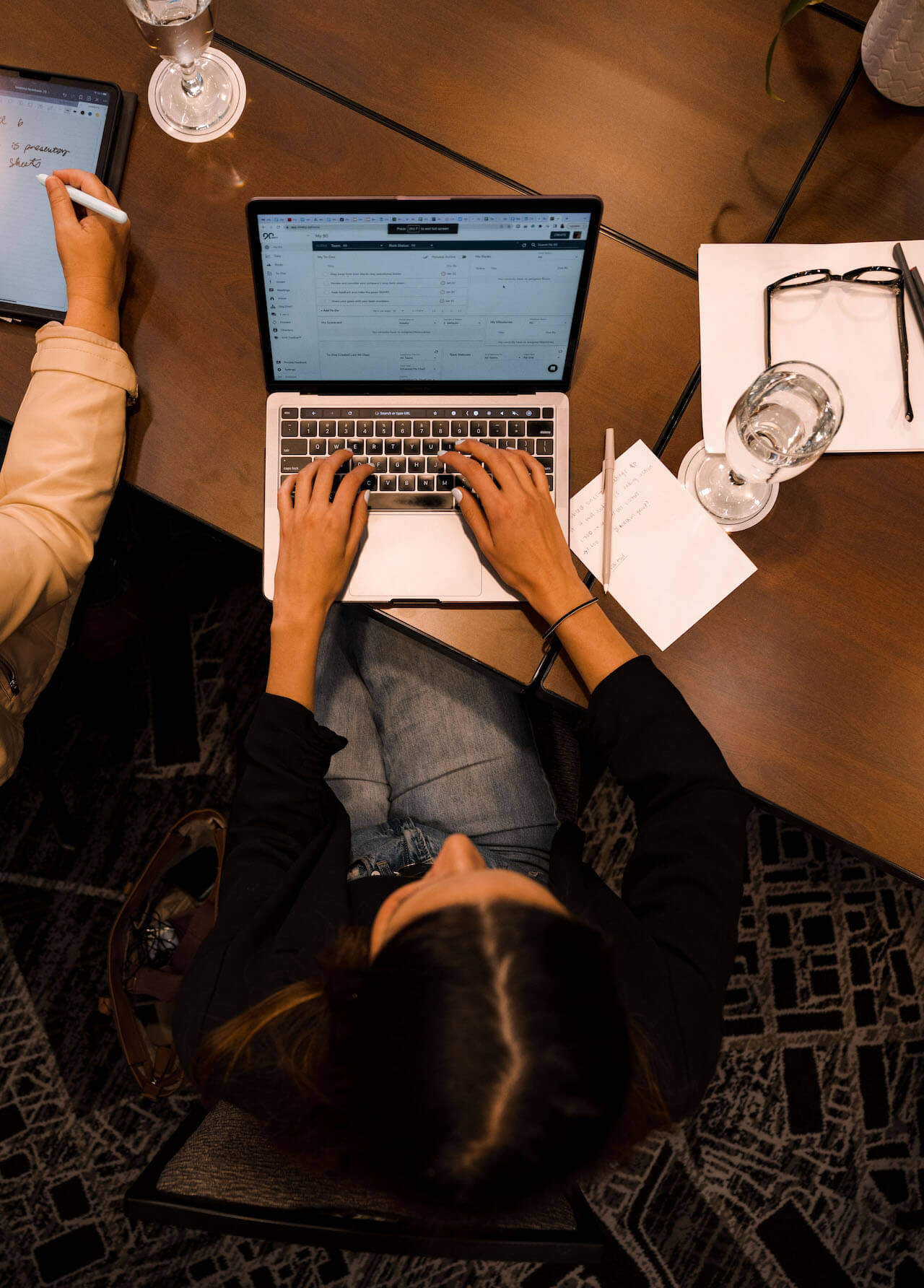 An overhead view of an employee working in the Ninety app on her laptop