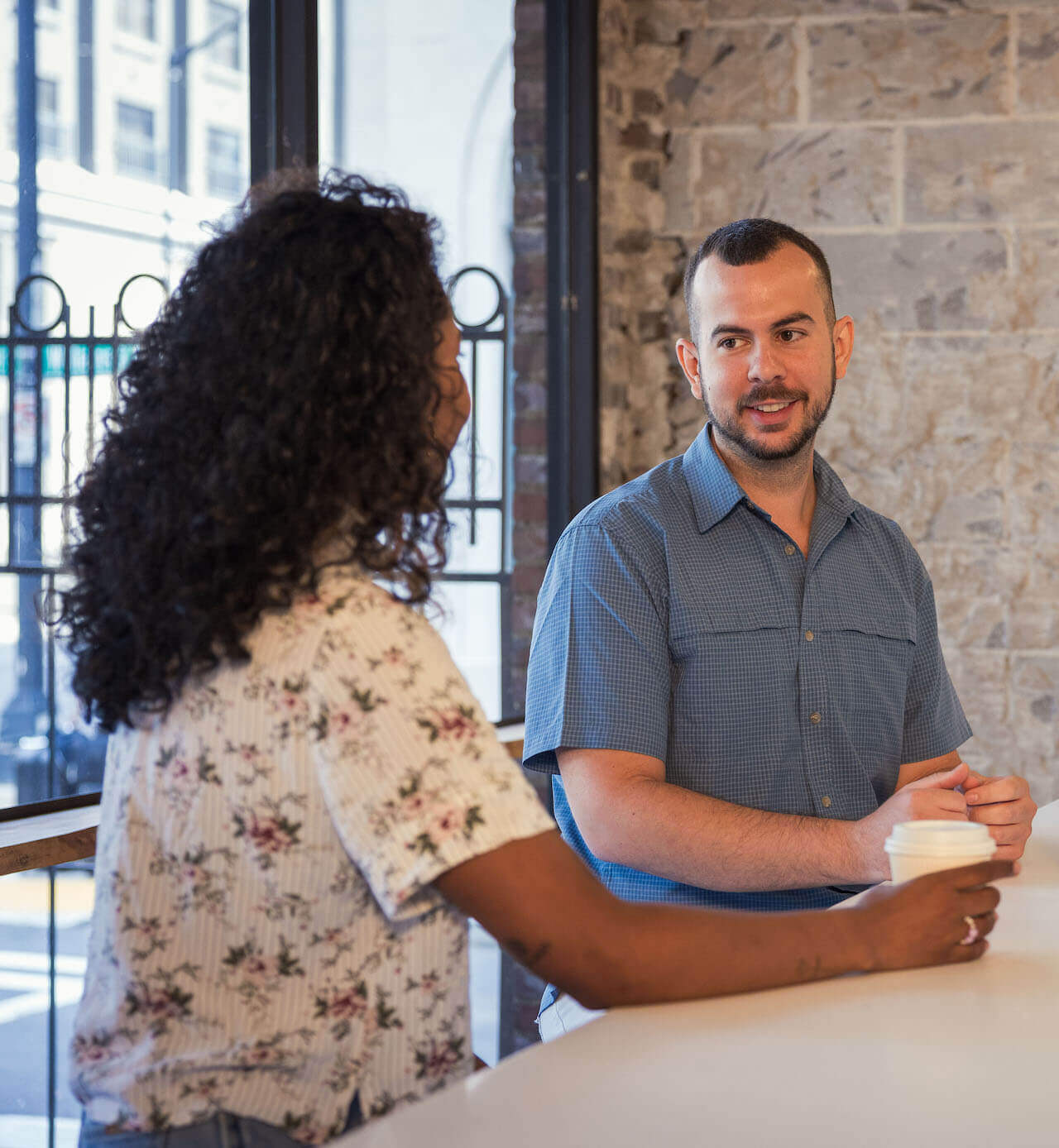 Two employees at a cafe having a conversation