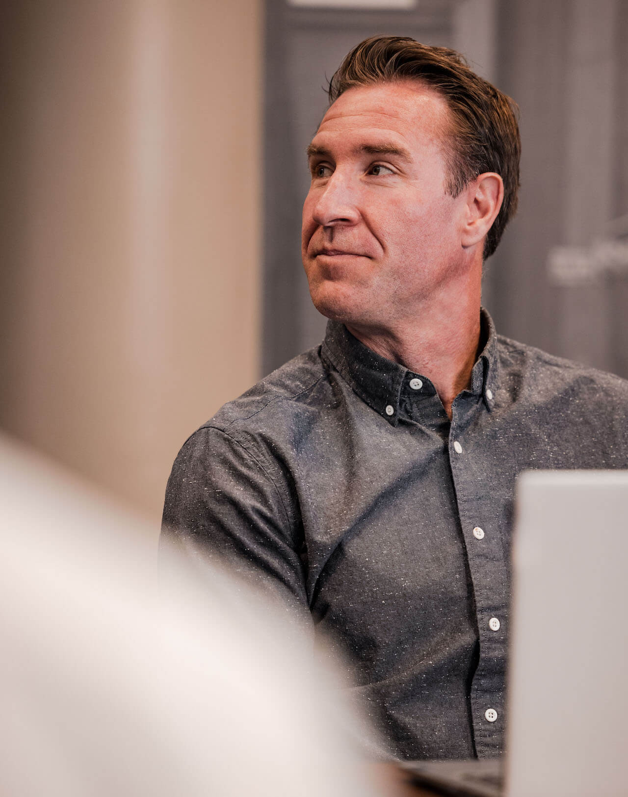An employee listening to the presenter during a meeting.