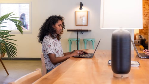 A woman types on a computer