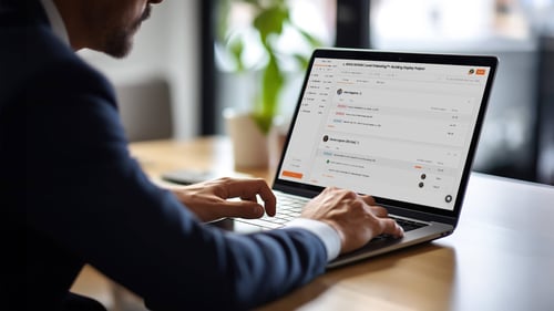 A person types on a laptop computer