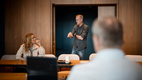 People having a conversation while sitting in a boardroom. 