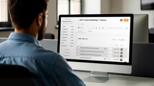 A man looks at a screen that shows a level 10 meeting.