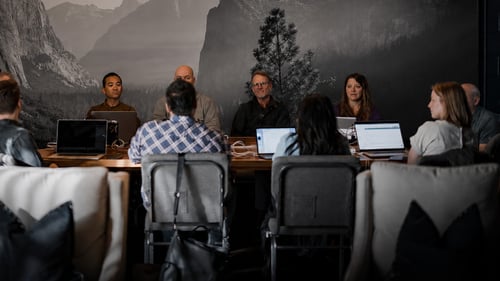 A team sitting around a table during a meeting. 