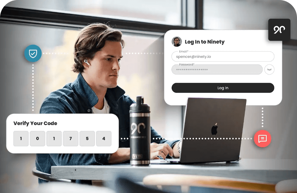 Person working on a laptop with Ninety login screen and multi-factor authentication code entry overlay.