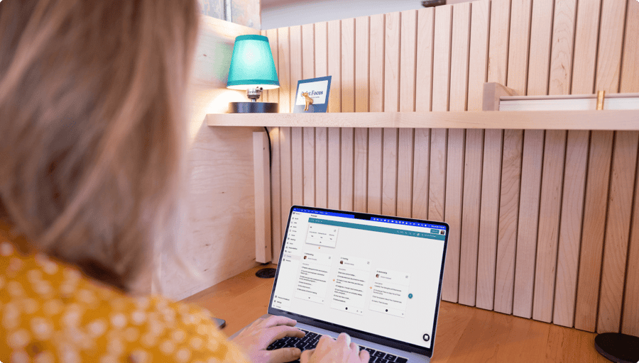 A woman at her desk viewing the Process tool on her laptop.