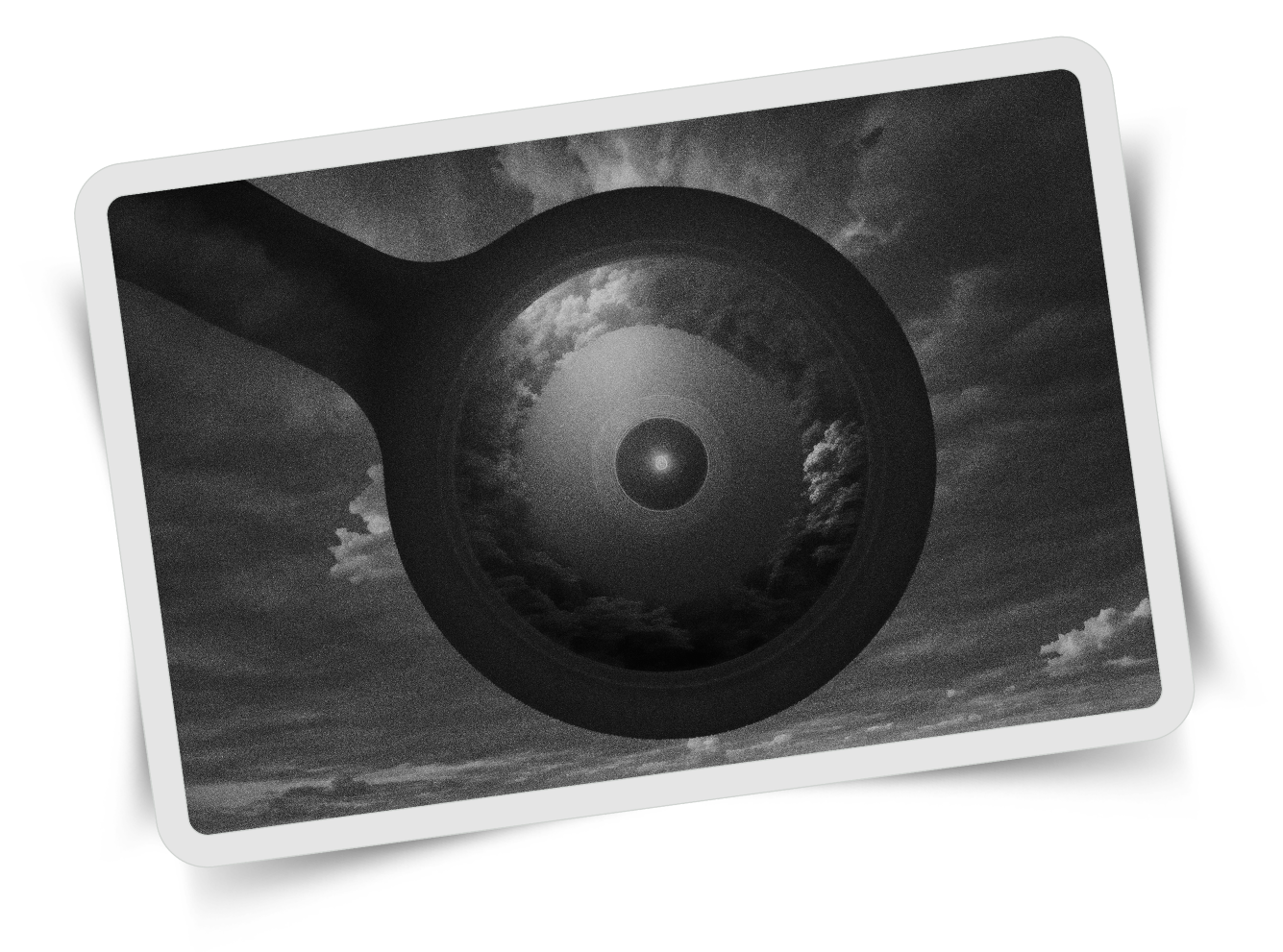 A black and white image featuring a large circular object resembling a camera lens or an eye, centered in the sky amidst swirling clouds. The circular object has a concentric design and a glowing point in the center, creating a cosmic, otherworldly atmosphere.