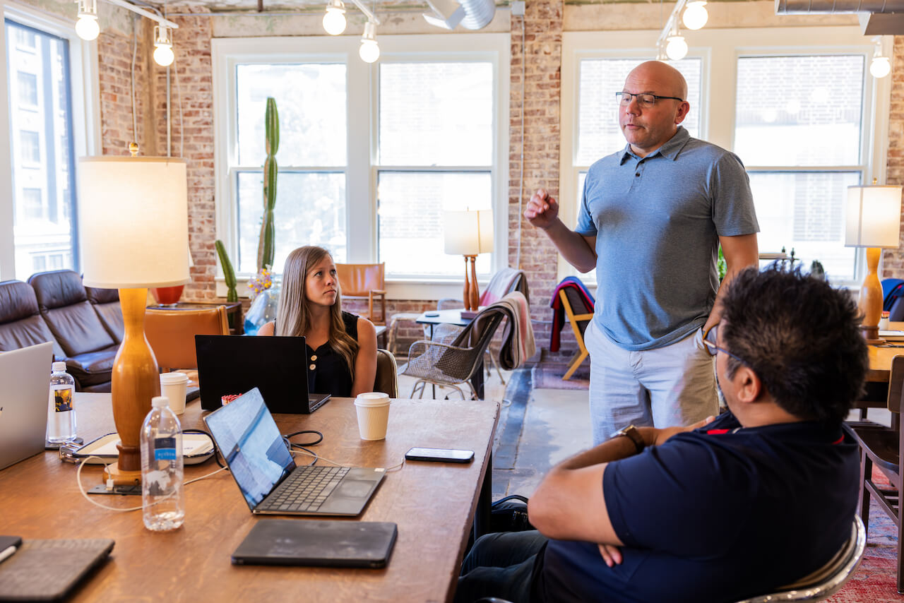 Kris Snyder of Ninety speaking to employees in a coworking space.