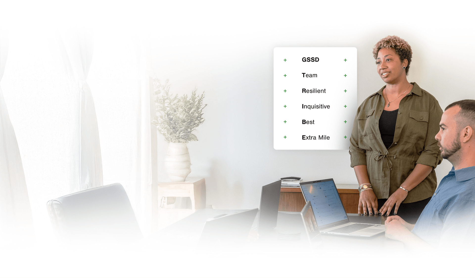 Same woman and man in a meeting, this time next to an overlay listing values like 'Team', 'Resilient', and 'Inquisitive' under 'GSSD'.
