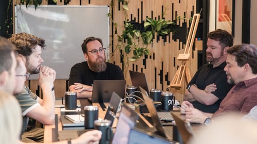 A man having a team collaboration session with his co-workers in an office.