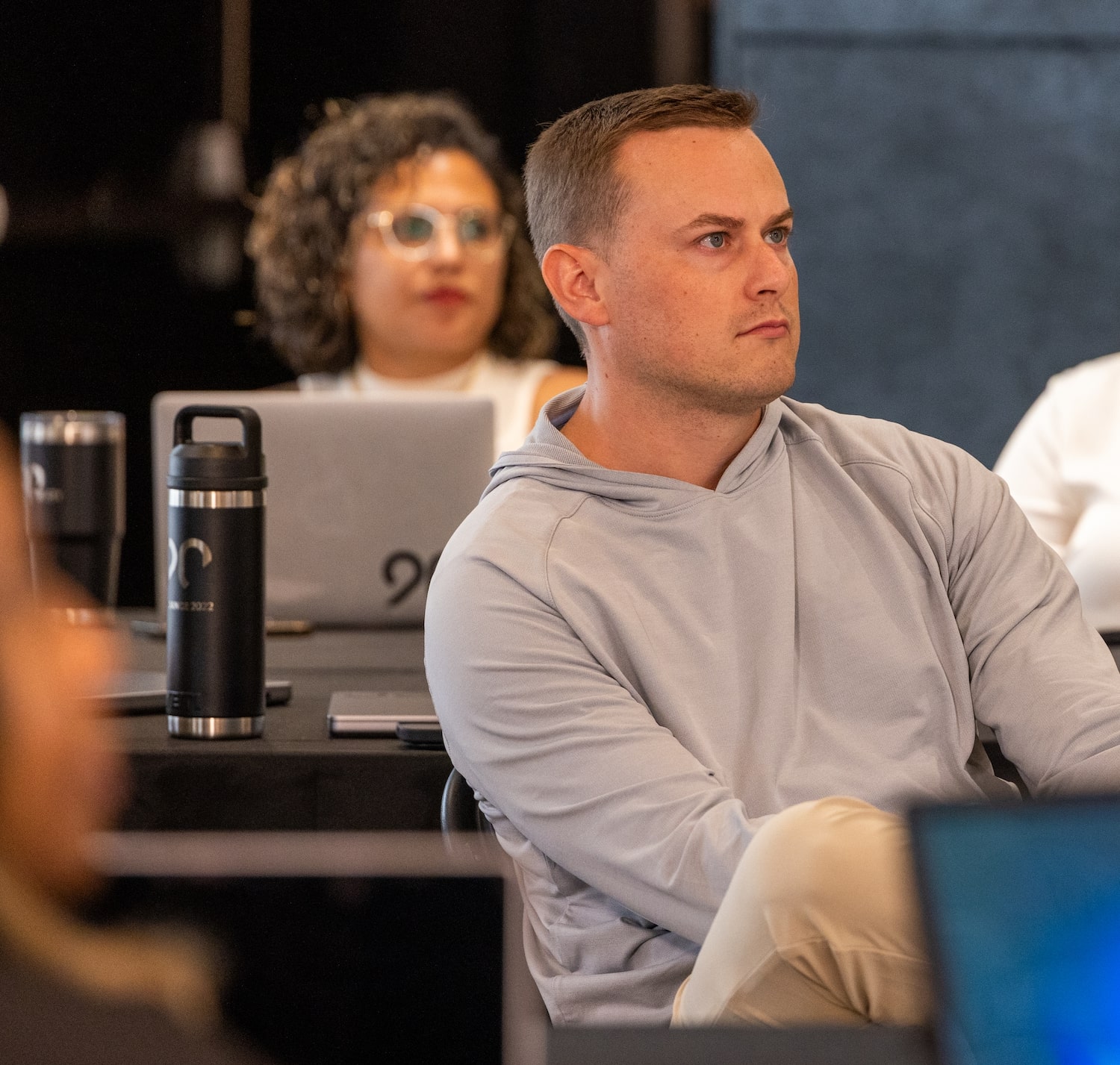 Ninety employees with their laptops listening to a presentation.