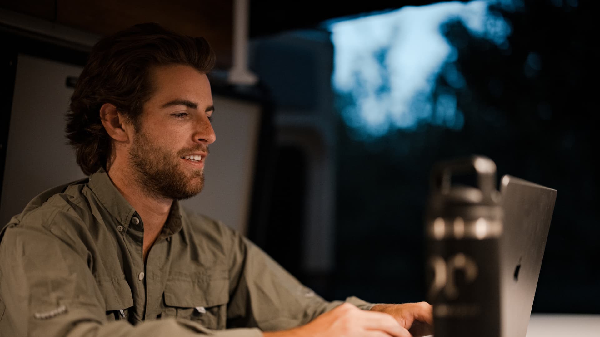 man working on laptop setting business goals