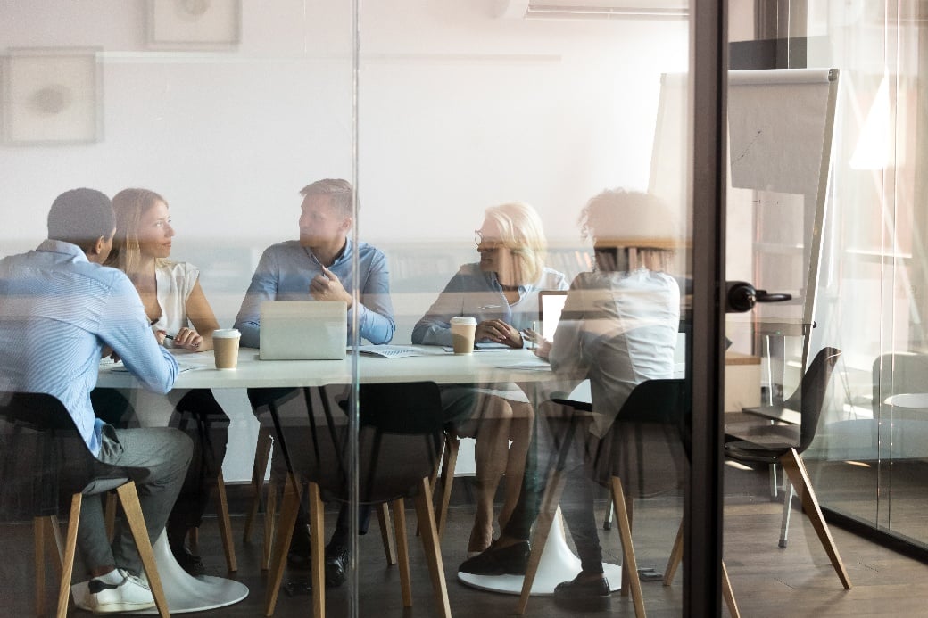 5 people meeting to discuss the agenda