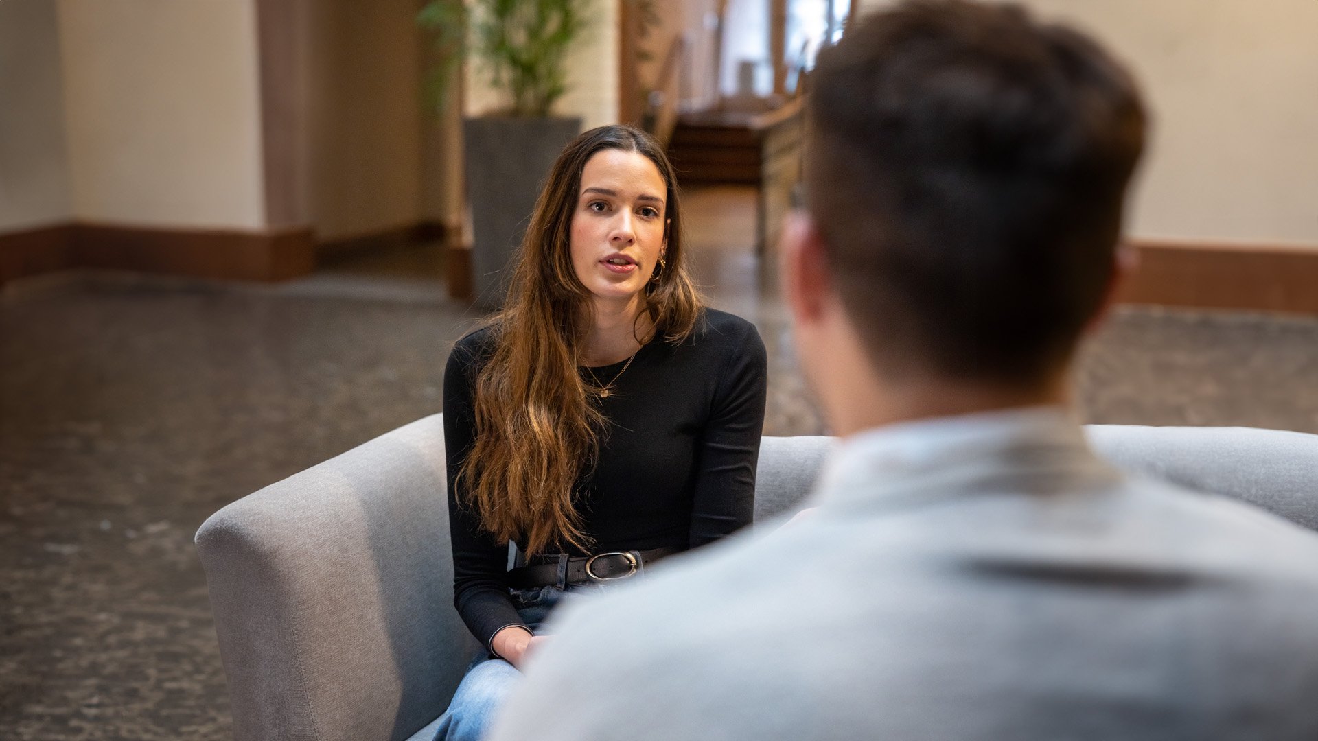Two coworkers having a focused one-on-one discussion in an office setting.