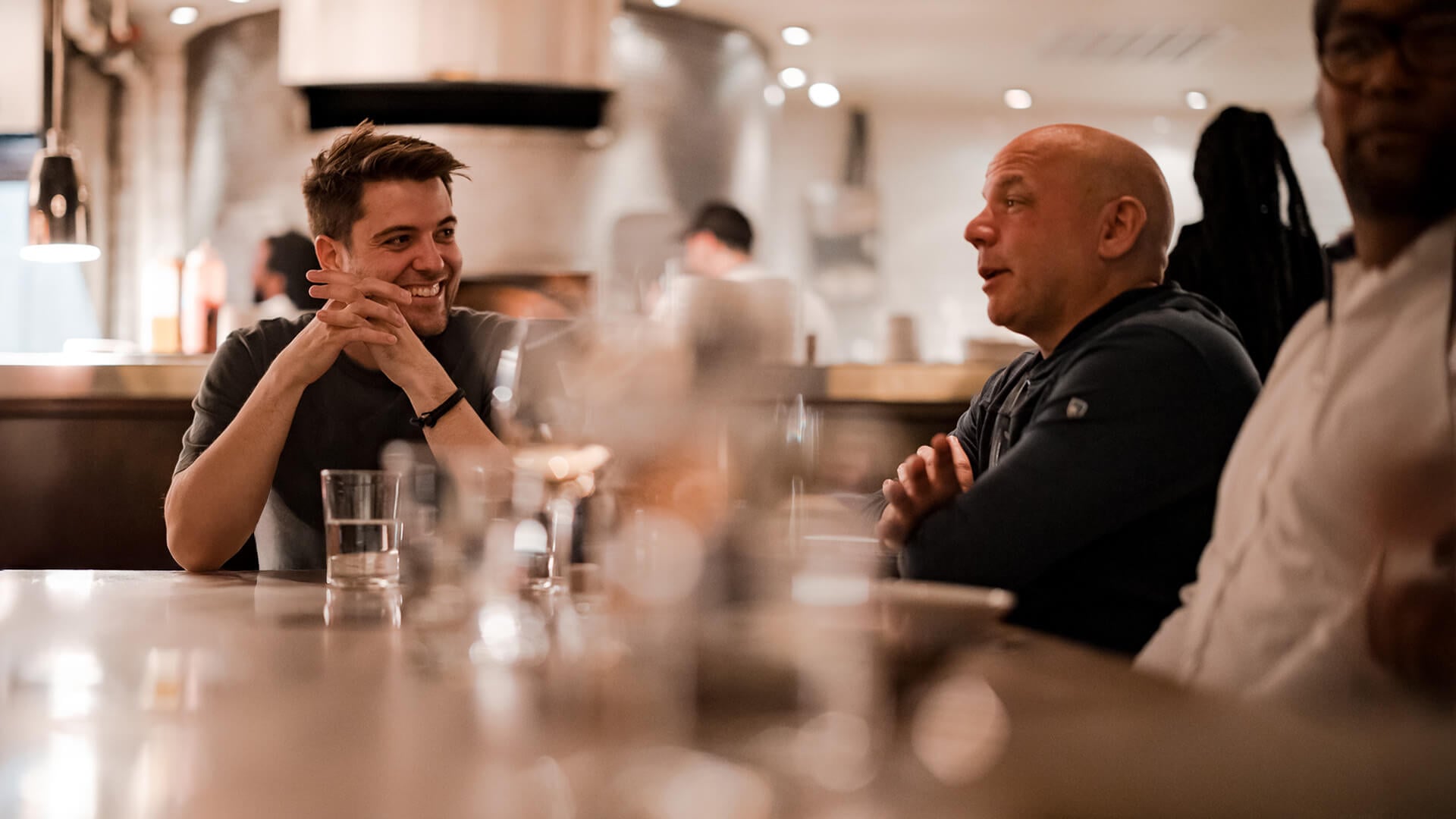 Two men sit at a table in a restaurant