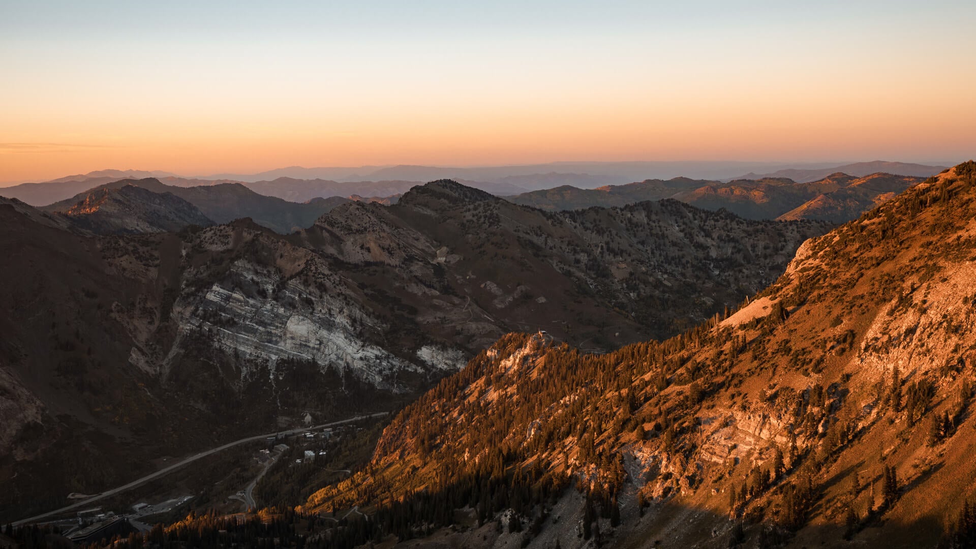 The sun setting on top of mountainous plains. 