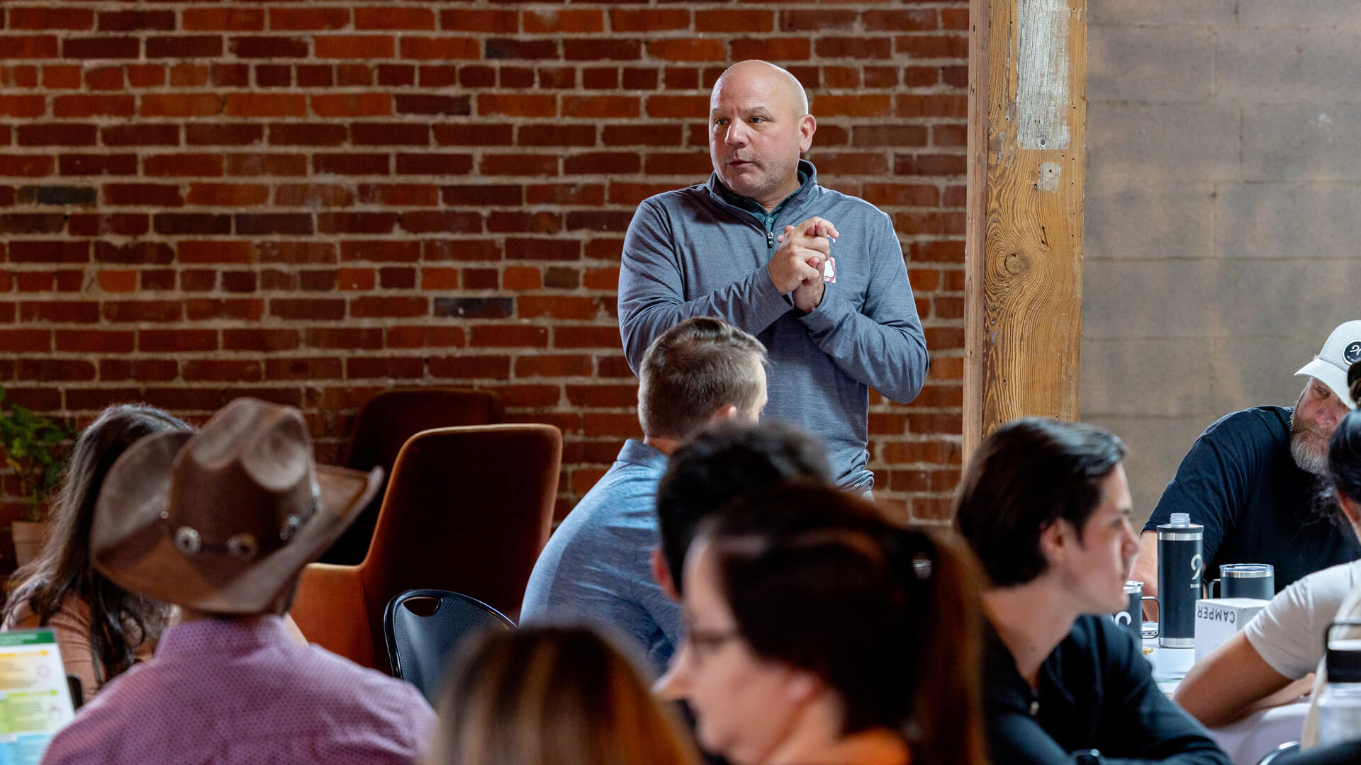 Kris Snyder, Ninety CRO, standing in front of a room leading a team meeting. 