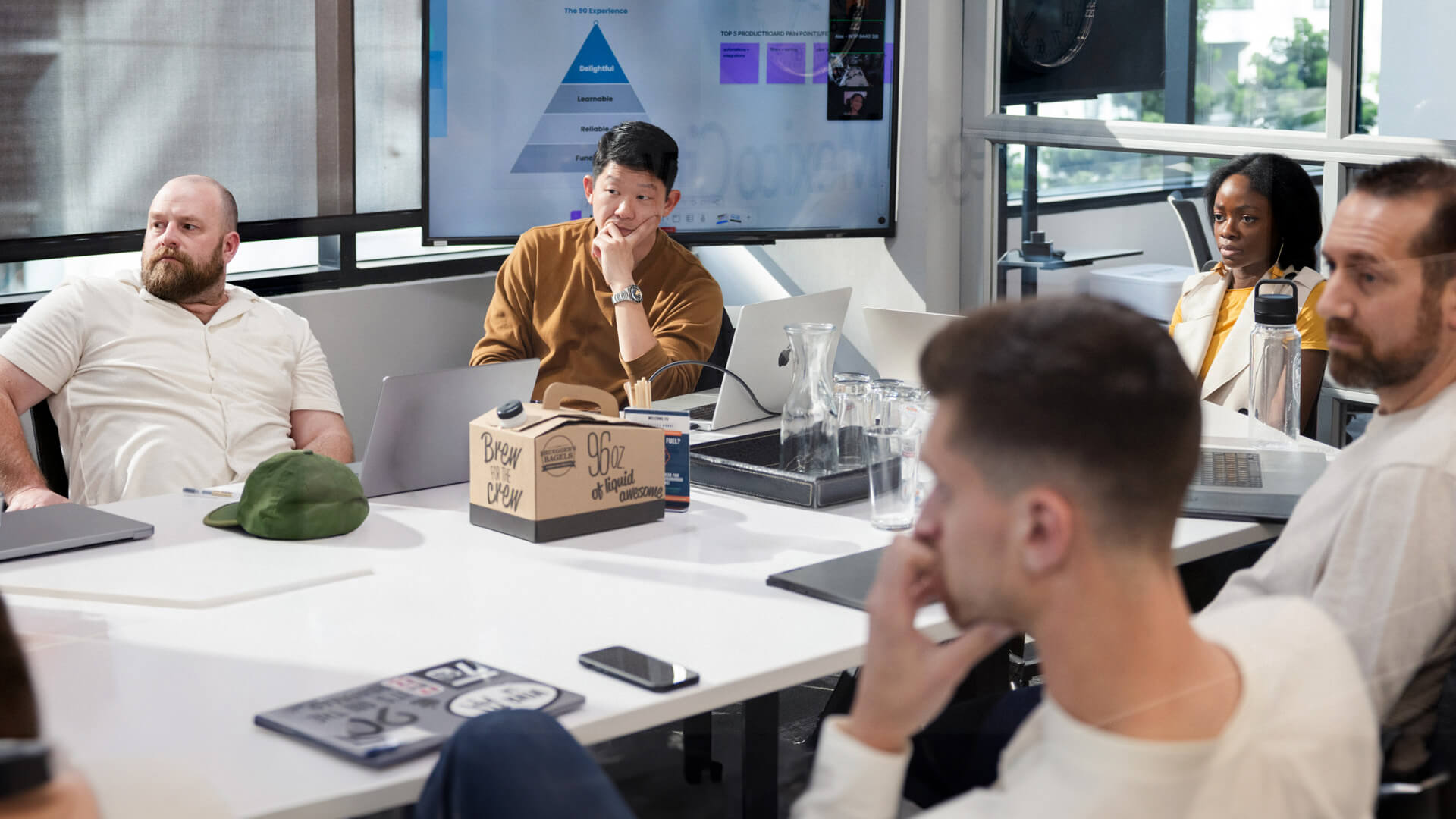 People sitting at a table in a conference room, meeting. 