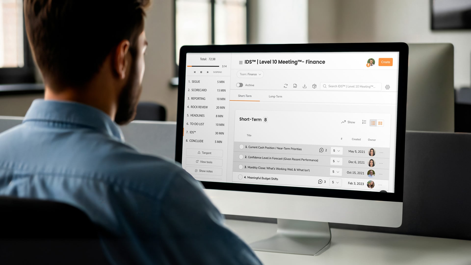 A man looks at a screen that shows a level 10 meeting.