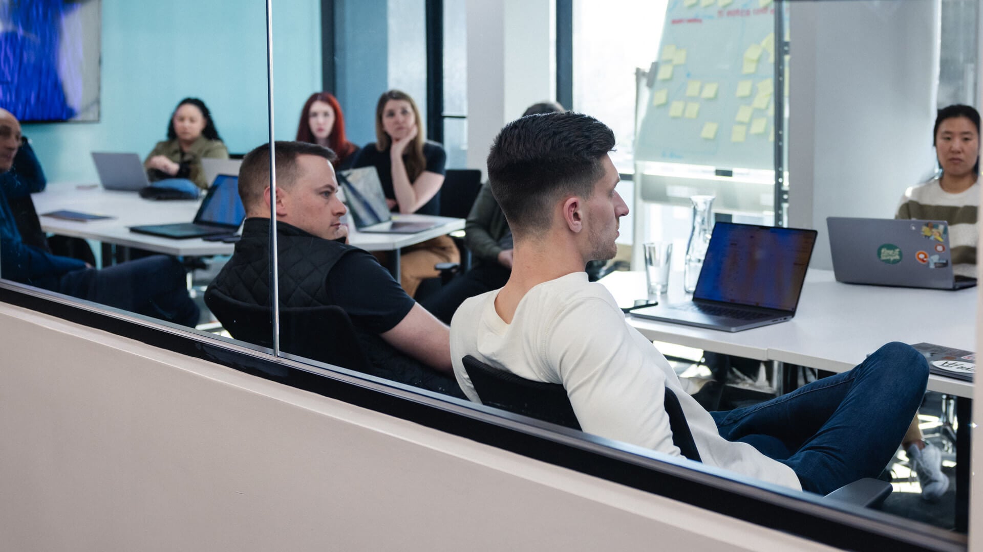 Several people sit around a conference room table.