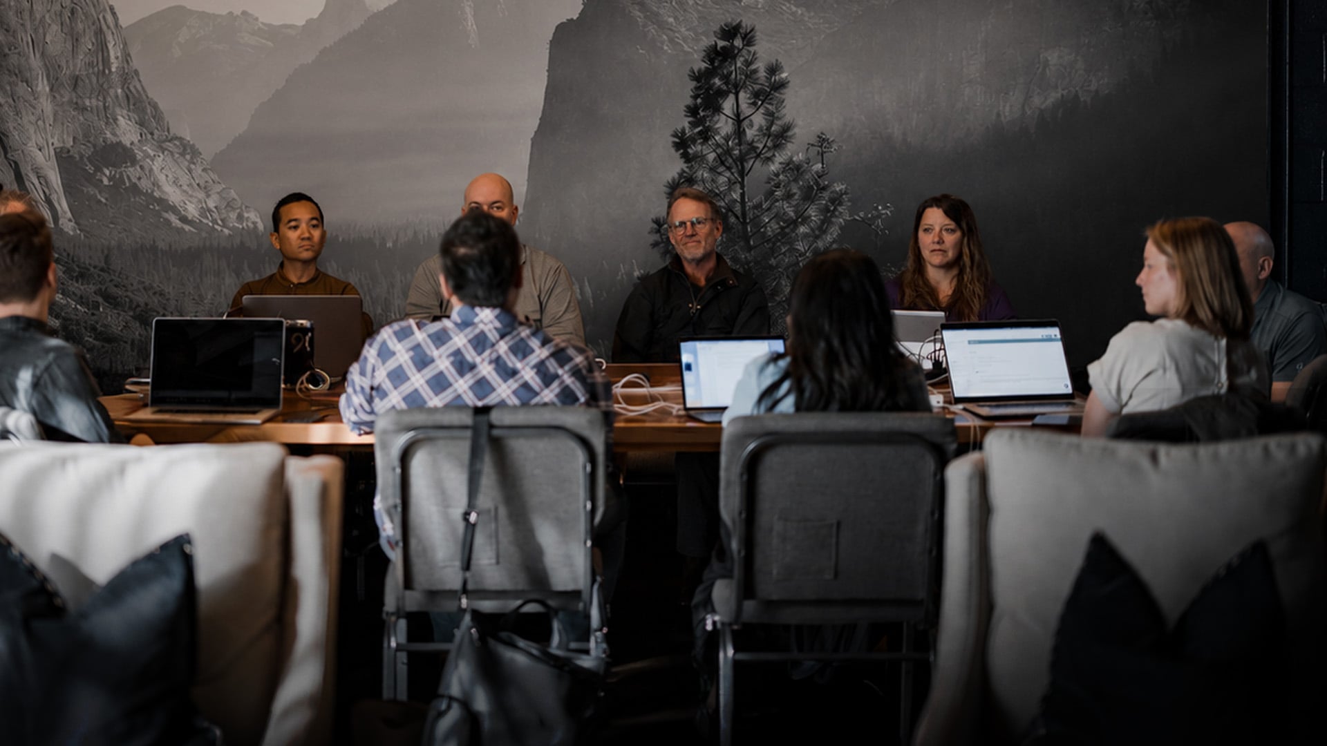 A team sitting around a table during a meeting. 